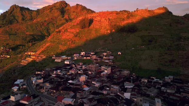 Aerial view of Dieng village and terraced hills at sunset Indonesia. Aerial view of Dieng village and terraced hills at sunset Indonesia.