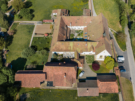 Aerial view of Monastere de Montorge with its historic red tiled roofs inner courtyards and surrounding green gardens in Fribourg Fribourg Switzerland.