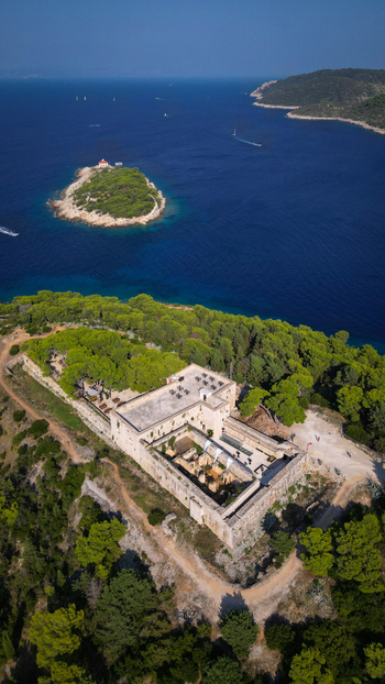 Aerial view of Fort George and the surrounding pine forest overlooking the Adriatic Sea and Host Island near Vis Splitsko dalmatinska Croatia. Aerial view of Fort George and the surrounding pine forest overlooking the Adriatic Sea and Host Island near Vis Splitsko dalmatinska Croatia.
