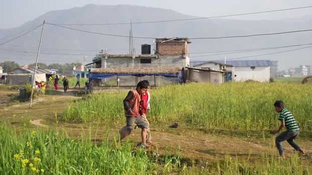 View of children playing in a field in Surkhet Nepal.