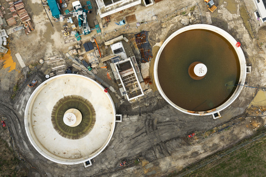 Diepenbeek Belgium 30 August 2026 Aerial view of the wastewater treatment plant construction site featuring large circular sedimentation tanks and industrial infrastructure. Diepenbeek Belgium 30 August 2026 Aerial view of the wastewater treatment plant construction site featuring large circular sedimentation tanks and industrial infrastructure.