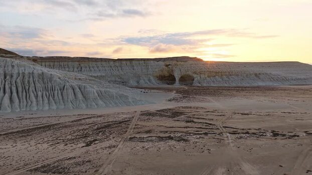 Aerial view of Tuzbair salt flats and white cliffs at sunset Kazakhstan.