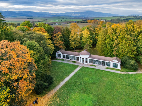 Aerial view of a grand white building with a central dome elegantly nestled amidst a vibrant tapestry of green golden and russet autumn foliage Mosovce Zilina Region Slovakia. Aerial view of a grand white building with a central dome elegantly nestled amidst a vibrant tapestry of green golden and russet autumn foliage Mosovce Zilina Region Slovakia.