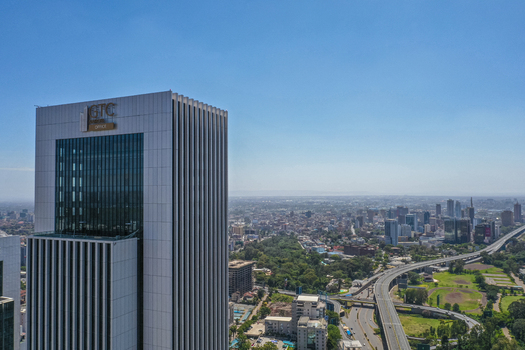 Aerial view of the GTC Office skyscraper in Westlands featuring modern glass and steel architecture surrounded by urban greenery and highway infrastructure in Nairobi Nairobi County Kenya. Aerial view of the GTC Office skyscraper in Westlands featuring modern glass and steel architecture surrounded by urban greenery and highway infrastructure in Nairobi Nairobi County Kenya.