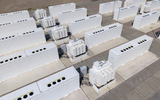 Aerial view of the Battery Energy Storage System at Wind Park with rows of white industrial battery containers and power transformers in Dronten Flevoland Netherlands. Aerial view of the Battery Energy Storage System at Wind Park with rows of white industrial battery containers and power transformers in Dronten Flevoland Netherlands.