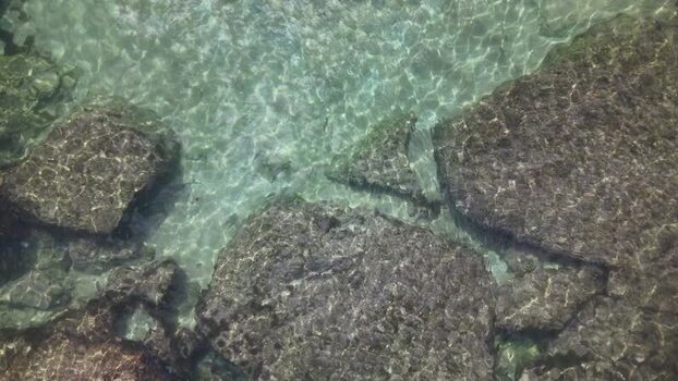 Aerial view of clear turquoise water over dark rocks Portugal. Aerial view of clear turquoise water over dark rocks Portugal.