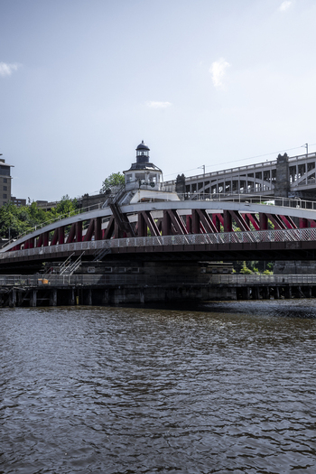 View of the historic Swing Bridge with its red steel structure and central control tower spanning the River Tyne in Newcastle upon Tyne England United Kingdom. View of the historic Swing Bridge with its red steel structure and central control tower spanning the River Tyne in Newcastle upon Tyne England United Kingdom.