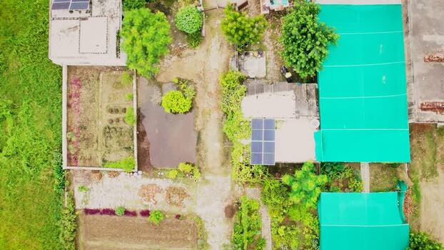 Aerial view of solar panels in a rural area India.