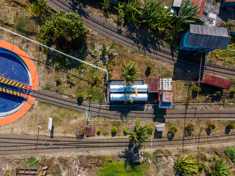 Aerial view of a railway turntable and storage tanks located near train tracks in Cilacap Central Java Indonesia. Aerial view of a railway turntable and storage tanks located near train tracks in Cilacap Central Java Indonesia.