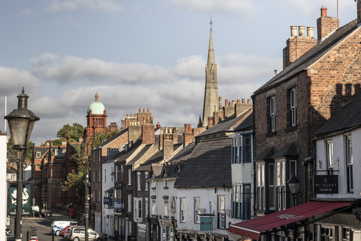 Durham United Kingdom 13 July 2026 View of Durham city center with its historic brick buildings church spire and street level storefronts under a partly cloudy sky. Durham United Kingdom 13 July 2026 View of Durham city center with its historic brick buildings church spire and street level storefronts under a partly cloudy sky.