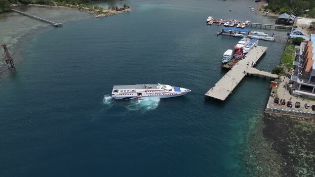 Aerial view of a ferry boat near the pier in Raja Ampat Indonesia. Aerial view of a ferry boat near the pier in Raja Ampat Indonesia.
