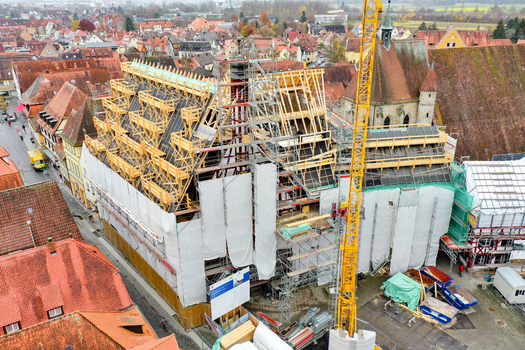 Aerial view of Rathaus Forchheim under renovation with scaffolding and a yellow crane among historic red tiled rooftops in Forchheim Bayern Germany. Aerial view of Rathaus Forchheim under renovation with scaffolding and a yellow crane among historic red tiled rooftops in Forchheim Bayern Germany.