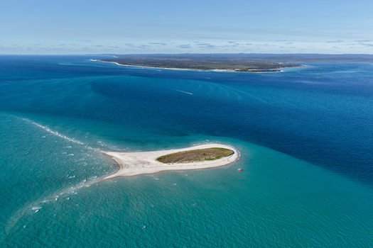 Aerial view of Pelican Bank a small sandy island surrounded by turquoise waters and the deep blue ocean near K gari Queensland Australia. Aerial view of Pelican Bank a small sandy island surrounded by turquoise waters and the deep blue ocean near K gari Queensland Australia.