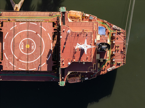 Aerial view of a cargo ship docked on the Rio Ozama showing the deck winches and navigation equipment in Santo Domingo Santo Domingo Dominican Republic.