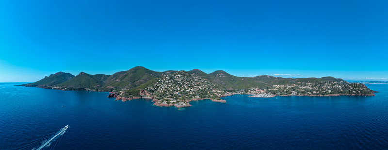 Aerial view of Le Trayas coastal landscape with rocky cliffs green hills and residential buildings overlooking the Mediterranean Sea in Saint Raphael Provence Alpes Cote d Azur France. Aerial view of Le Trayas coastal landscape with rocky cliffs green hills and residential buildings overlooking the Mediterranean Sea in Saint Raphael Provence Alpes Cote d Azur France.