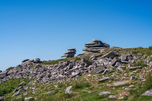 View of the Cheesewring granite rock formation set within the rugged moorland landscape of Minions Cornwall United Kingdom. View of the Cheesewring granite rock formation set within the rugged moorland landscape of Minions Cornwall United Kingdom.