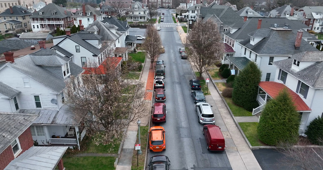 Aerial view of Derry Township residential street lined with houses parked cars and trees in Hershey Pennsylvania United States. Aerial view of Derry Township residential street lined with houses parked cars and trees in Hershey Pennsylvania United States.