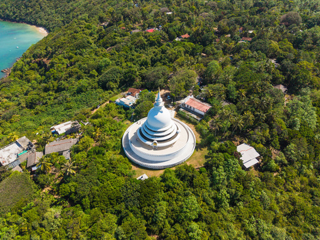 Aerial view of the Japanese Peace Pagoda Rumassala surrounded by lush tropical forest and the turquoise ocean in Unawatuna Southern Province Sri Lanka. Aerial view of the Japanese Peace Pagoda Rumassala surrounded by lush tropical forest and the turquoise ocean in Unawatuna Southern Province Sri Lanka.