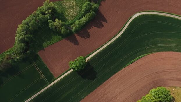 Aerial view of agricultural fields and a winding road Germany.