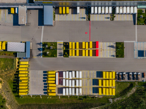 Aerial view of Logistikzentrum Allhaming with rows of yellow trucks and trailers parked in the logistics yard in Allhaming Oberosterreich Austria. Aerial view of Logistikzentrum Allhaming with rows of yellow trucks and trailers parked in the logistics yard in Allhaming Oberosterreich Austria.