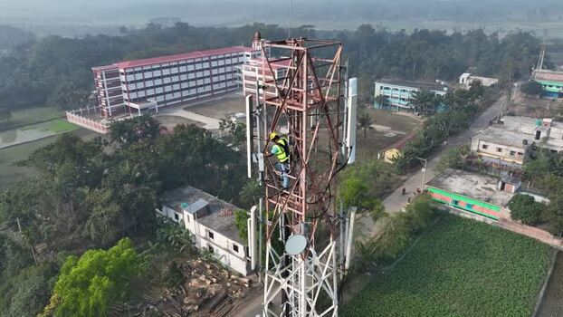 Aerial view of a technician working on a cell tower Bangladesh.
