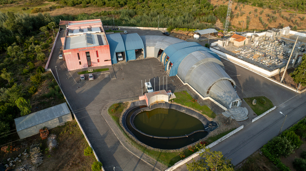 Vila Nova de Oliveirinha Portugal Aerial view of the Bombeiros Voluntarios fire station with its unique curved roof structure like a fire hose adjacent pond and surrounding rural landscape. Vila Nova de Oliveirinha Portugal Aerial view of the Bombeiros Voluntarios fire station with its unique curved roof structure like a fire hose adjacent pond and surrounding rural landscape.