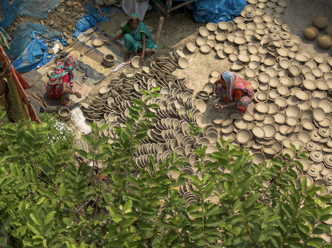 Joypurhat Bangladesh 28 September 2026 Aerial view of women working with clay pottery in an outdoor workspace with rows of drying pots and green foliage. Joypurhat Bangladesh 28 September 2026 Aerial view of women working with clay pottery in an outdoor workspace with rows of drying pots and green foliage.
