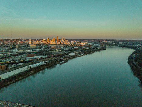 Aerial view of the Ohio River reflecting the golden sunset light against the Cincinnati skyline Cincinnati Ohio United States. Aerial view of the Ohio River reflecting the golden sunset light against the Cincinnati skyline Cincinnati Ohio United States.