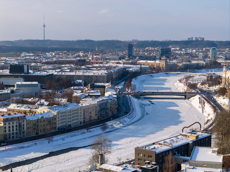 Aerial view of the frozen Neris river winding through the snow covered cityscape of Vilnius with the TV tower in the distance Vilnius County Lithuania.