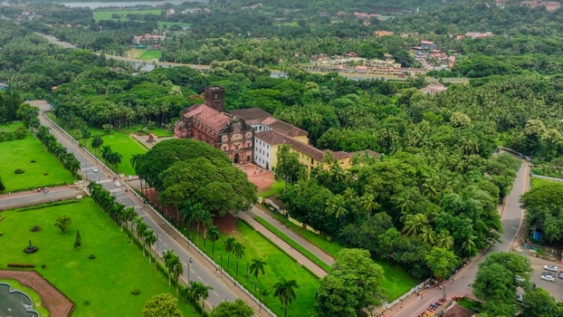 Aerial view of the Church of St. Francis of Assisi surrounded by lush green trees manicured lawns and roads in Old Goa Goa India. Aerial view of the Church of St. Francis of Assisi surrounded by lush green trees manicured lawns and roads in Old Goa Goa India.
