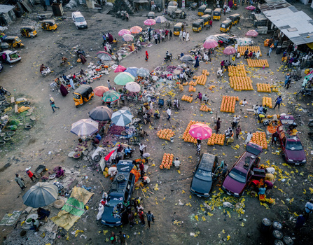 Aerial view of Panteka Market with busy stalls colorful umbrellas and yellow auto rickshaws in Kaduna Kaduna Nigeria. Aerial view of Panteka Market with busy stalls colorful umbrellas and yellow auto rickshaws in Kaduna Kaduna Nigeria.
