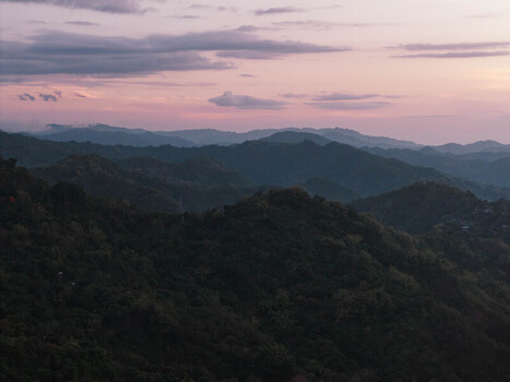 Cebu City Philippines 20 May 2026 Aerial view of the rolling hills of Busay under a twilight sky with pink and purple clouds at dusk.