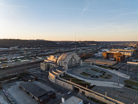 Aerial view of the grand art deco Cincinnati Museum Center at Union Terminal glimmers under a warm sunset glow Cincinnati Ohio United States. Aerial view of the grand art deco Cincinnati Museum Center at Union Terminal glimmers under a warm sunset glow Cincinnati Ohio United States.