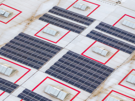 Aerial view of solar panels installed on a flat industrial roof with multiple skylights in Breclav South Moravian Region Czechia.
