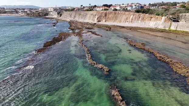 Aerial view of Praia das Avencas rocky coastline Portugal.