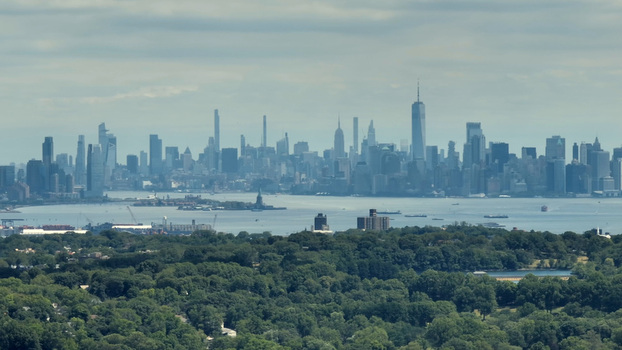 Aerial view of the Staten Island Greenbelt in the foreground with the New York City skyline across the harbor in New York New York United States.