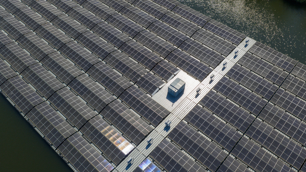 Aerial view of a large floating solar farm with rows of photovoltaic panels on a lake under bright sunlight Zwolle Overijssel Netherlands. Aerial view of a large floating solar farm with rows of photovoltaic panels on a lake under bright sunlight Zwolle Overijssel Netherlands.