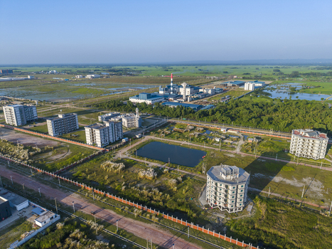 Aerial view of Mirsarai Economic Zone featuring industrial facilities modern residential buildings a central pond and surrounding green landscapes in Minsarai Chittagong Division Bangladesh. Aerial view of Mirsarai Economic Zone featuring industrial facilities modern residential buildings a central pond and surrounding green landscapes in Minsarai Chittagong Division Bangladesh.