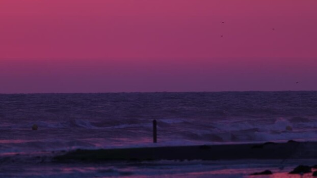 View of a magenta sky over the sea France.