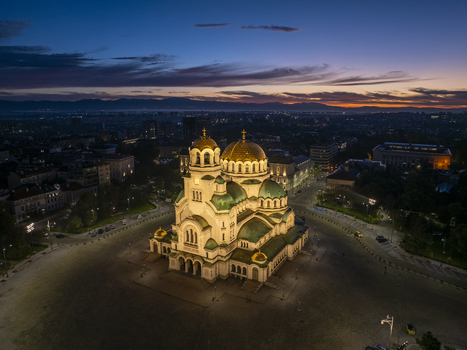Aerial view of Patriarchal Cathedral St. Alexander Nevsky illuminated at twilight with golden domes and green roofs in the city center of Sofia Sofia City Province Bulgaria. Aerial view of Patriarchal Cathedral St. Alexander Nevsky illuminated at twilight with golden domes and green roofs in the city center of Sofia Sofia City Province Bulgaria.