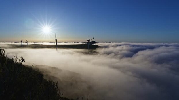 View of Bica da Cana wind turbines above clouds Portugal.
