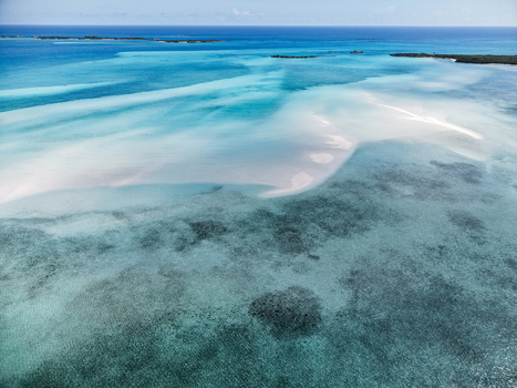 Aerial view of the Man O War Cay Sandbar with crystal clear turquoise waters and white sandbanks Rolletown Exuma The Bahamas. Aerial view of the Man O War Cay Sandbar with crystal clear turquoise waters and white sandbanks Rolletown Exuma The Bahamas.