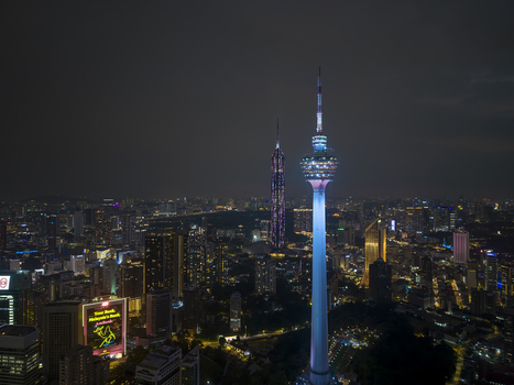 Kuala Lumpur Malaysia 11 March 2026 Aerial view of the illuminated Kuala Lumpur Tower and Merdeka 118 tower amidst the glowing city skyline at night.