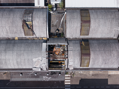 Aerial view of industrial warehouse rooftops with corrugated metal sheets and a central open section in Casale Monferrato Piedmont Italy. Aerial view of industrial warehouse rooftops with corrugated metal sheets and a central open section in Casale Monferrato Piedmont Italy.