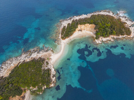Aerial view of the Ksamil islands featuring turquoise waters sandy beaches rocky cliffs and lush green vegetation in Ksamil Vlore County Albania. Aerial view of the Ksamil islands featuring turquoise waters sandy beaches rocky cliffs and lush green vegetation in Ksamil Vlore County Albania.
