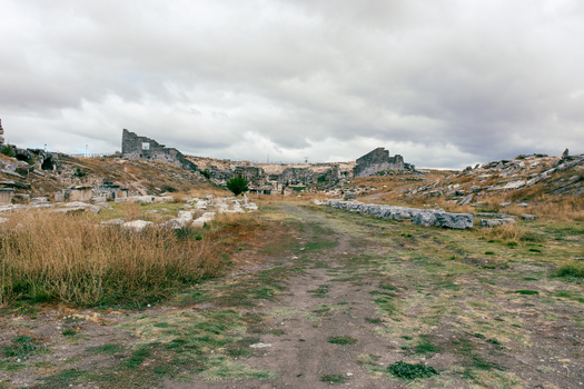 View of the ancient ruins of Aizonai with scattered stone structures and archaeological remains under a cloudy sky in Cavdarhisar Kutahya Turkiye. View of the ancient ruins of Aizonai with scattered stone structures and archaeological remains under a cloudy sky in Cavdarhisar Kutahya Turkiye.