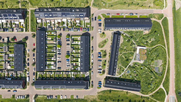 Aerial view of Ecodorp Zuiderveld featuring modern sustainable housing with solar panels lush green gardens and organized parking areas in Nijmegen Gelderland Netherlands. Aerial view of Ecodorp Zuiderveld featuring modern sustainable housing with solar panels lush green gardens and organized parking areas in Nijmegen Gelderland Netherlands.
