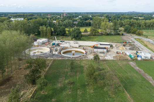 Vilvoorde Flanders Belgium 30 August 2026 Aerial view of a wastewater treatment plant with circular sedimentation tanks construction machinery and surrounding green fields. Vilvoorde Flanders Belgium 30 August 2026 Aerial view of a wastewater treatment plant with circular sedimentation tanks construction machinery and surrounding green fields.