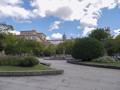 View of Plaza Obispo Cesareo with a central fountain manicured shrubs stone paving and historic buildings in Ourense Province of Ourense Spain. View of Plaza Obispo Cesareo with a central fountain manicured shrubs stone paving and historic buildings in Ourense Province of Ourense Spain.