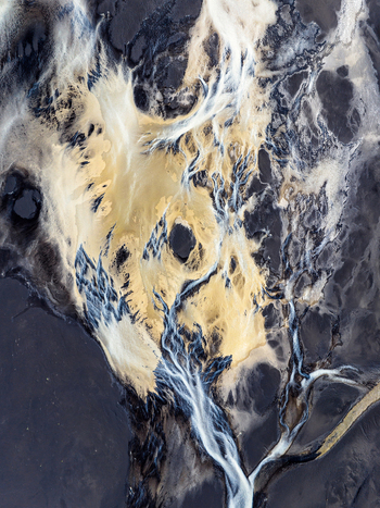 Aerial view of a braided river system with glacial sediment and dark volcanic sand in Iceland. Aerial view of a braided river system with glacial sediment and dark volcanic sand in Iceland.